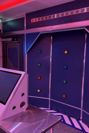 Interactive escape room with a touchscreen monitor and illuminated button wall.